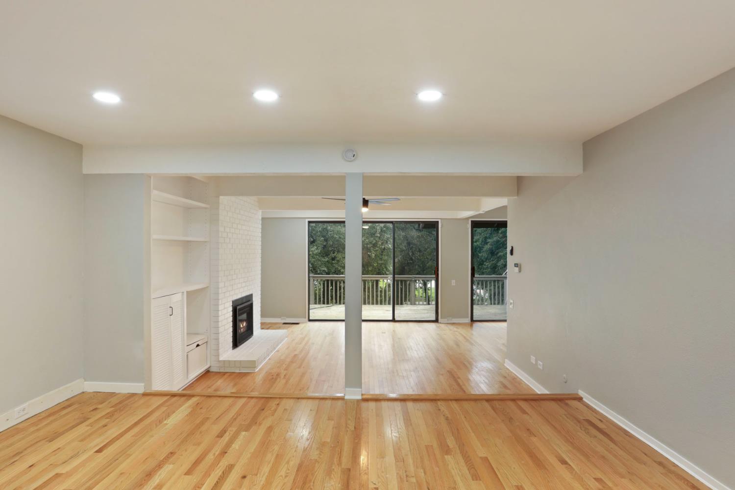 1917 Edgebrook Drive, Unit D Modesto, CA 95354 - Photo 26 of 58 a view of an empty room with wooden floor and a window