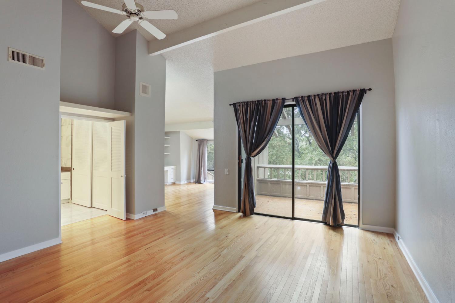 1917 Edgebrook Drive, Unit D Modesto, CA 95354 - Photo 27 of 58 an empty room with wooden floor fan and windows