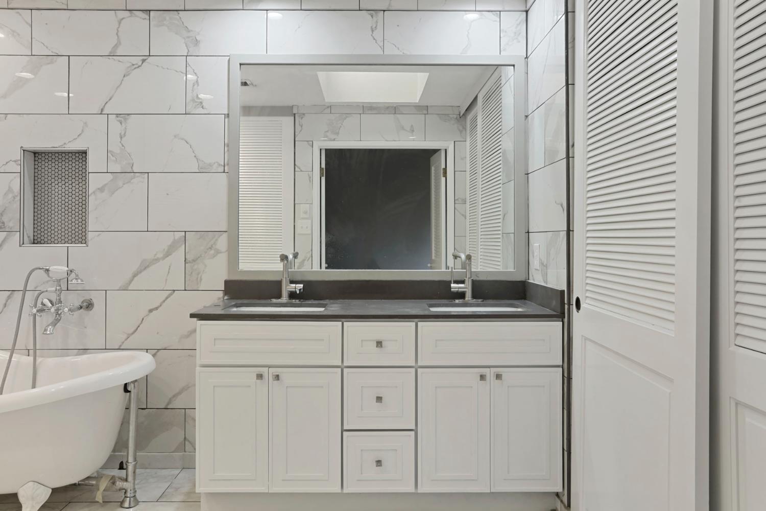 1917 Edgebrook Drive, Unit D Modesto, CA 95354 - Photo 32 of 58 a bathroom with a granite countertop sink and a mirror