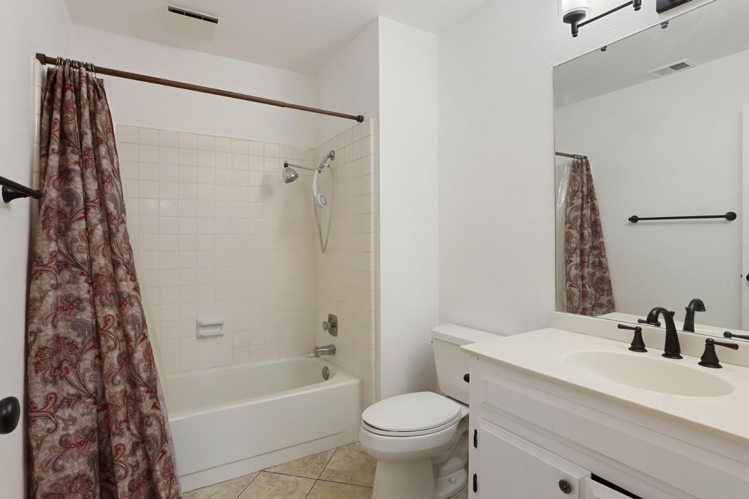 1917 Edgebrook Drive, Unit D Modesto, CA 95354 - Photo 37 of 58 a bathroom with a sink toilet and shower
