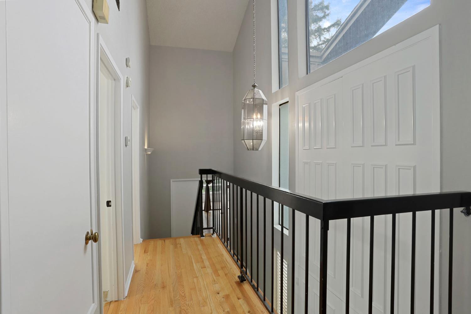 1917 Edgebrook Drive, Unit D Modesto, CA 95354 - Photo 43 of 58 a view of a hallway with wooden floor and staircase
