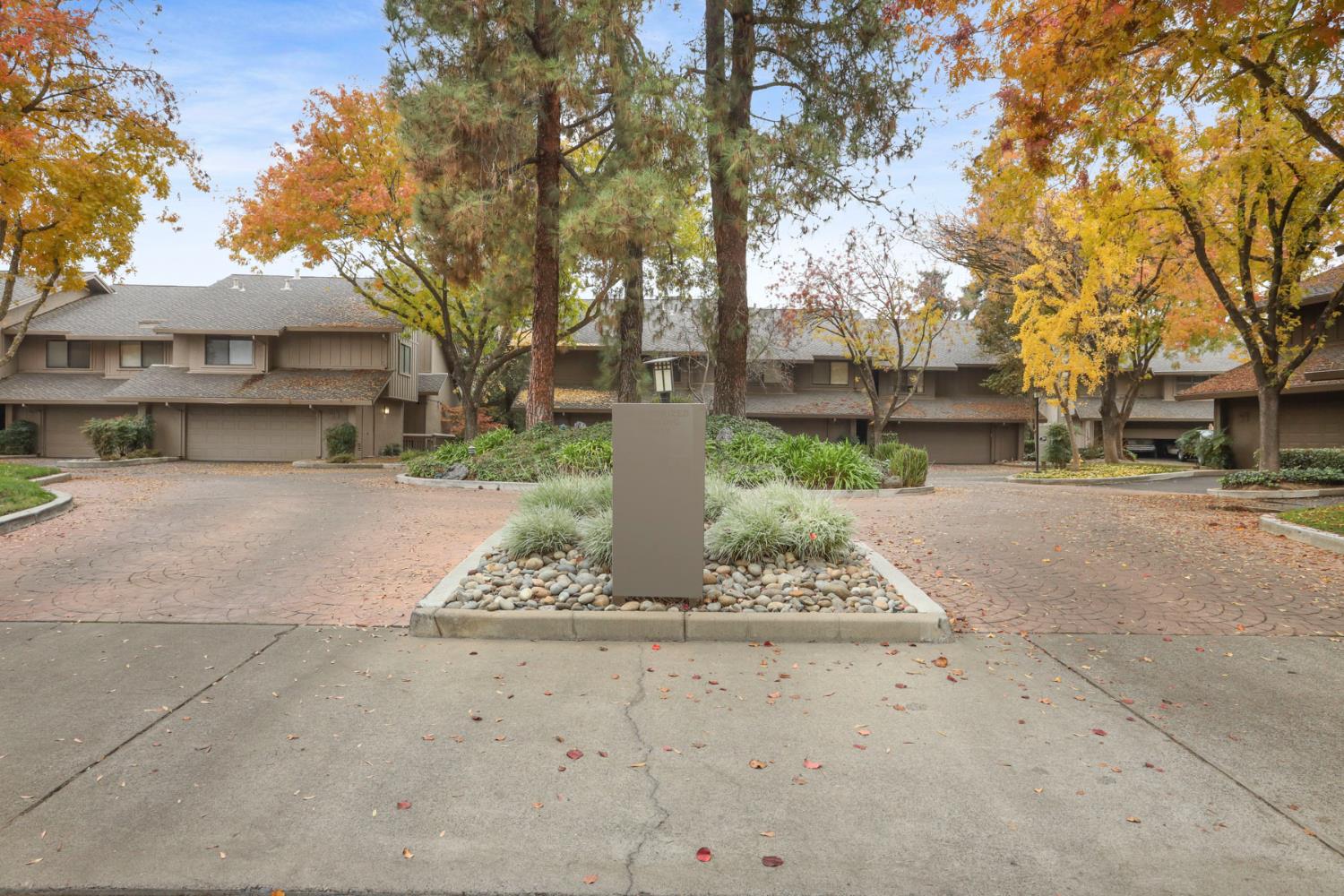 1917 Edgebrook Drive, Unit D Modesto, CA 95354 - Photo 5 of 58 a view of a street with a building and trees in the background
