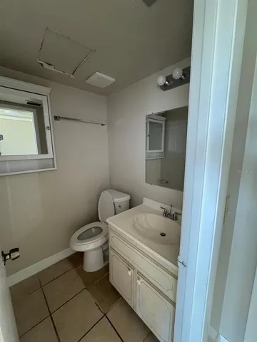 a bathroom with a sink toilet and vanity