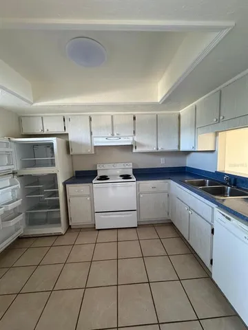 a kitchen with a white cabinets and white appliances