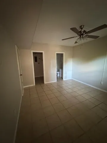 a view of an empty room with a ceiling fan