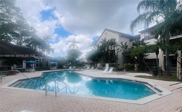 a view of a swimming pool with a patio