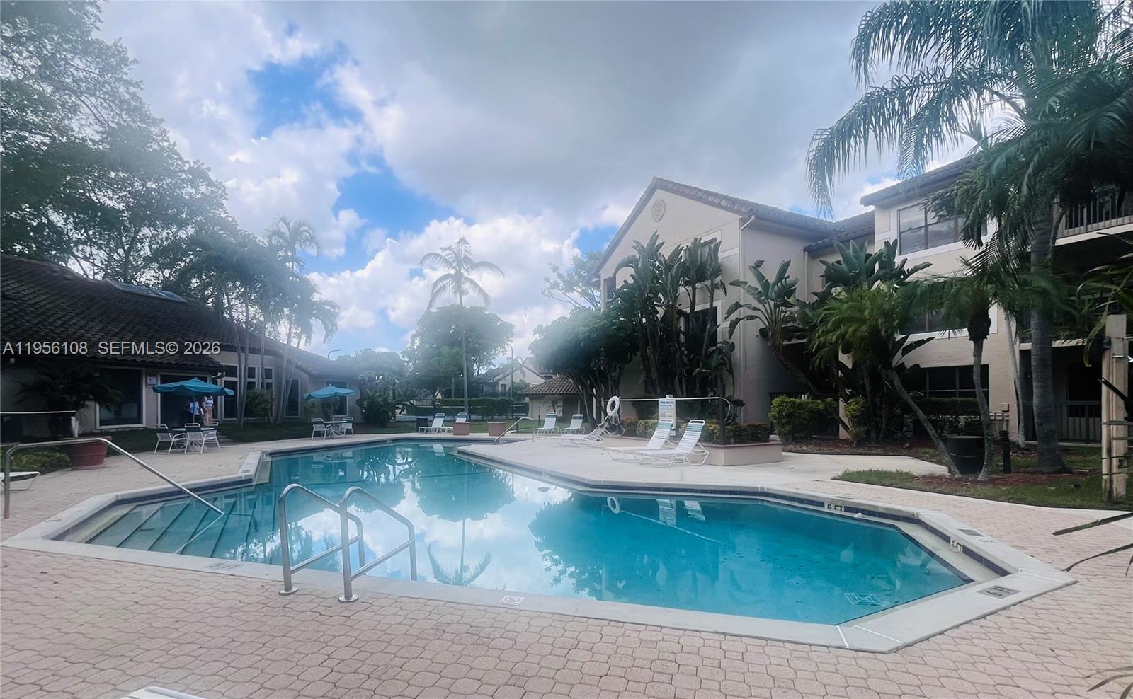 4281 West McNab Road, Unit 10 Pompano Beach, FL 33069 - Photo 14 of 16 a view of a swimming pool with a patio