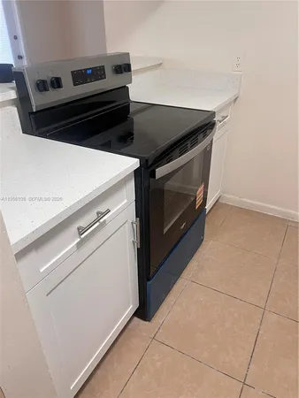 a stove top oven sitting inside of a kitchen