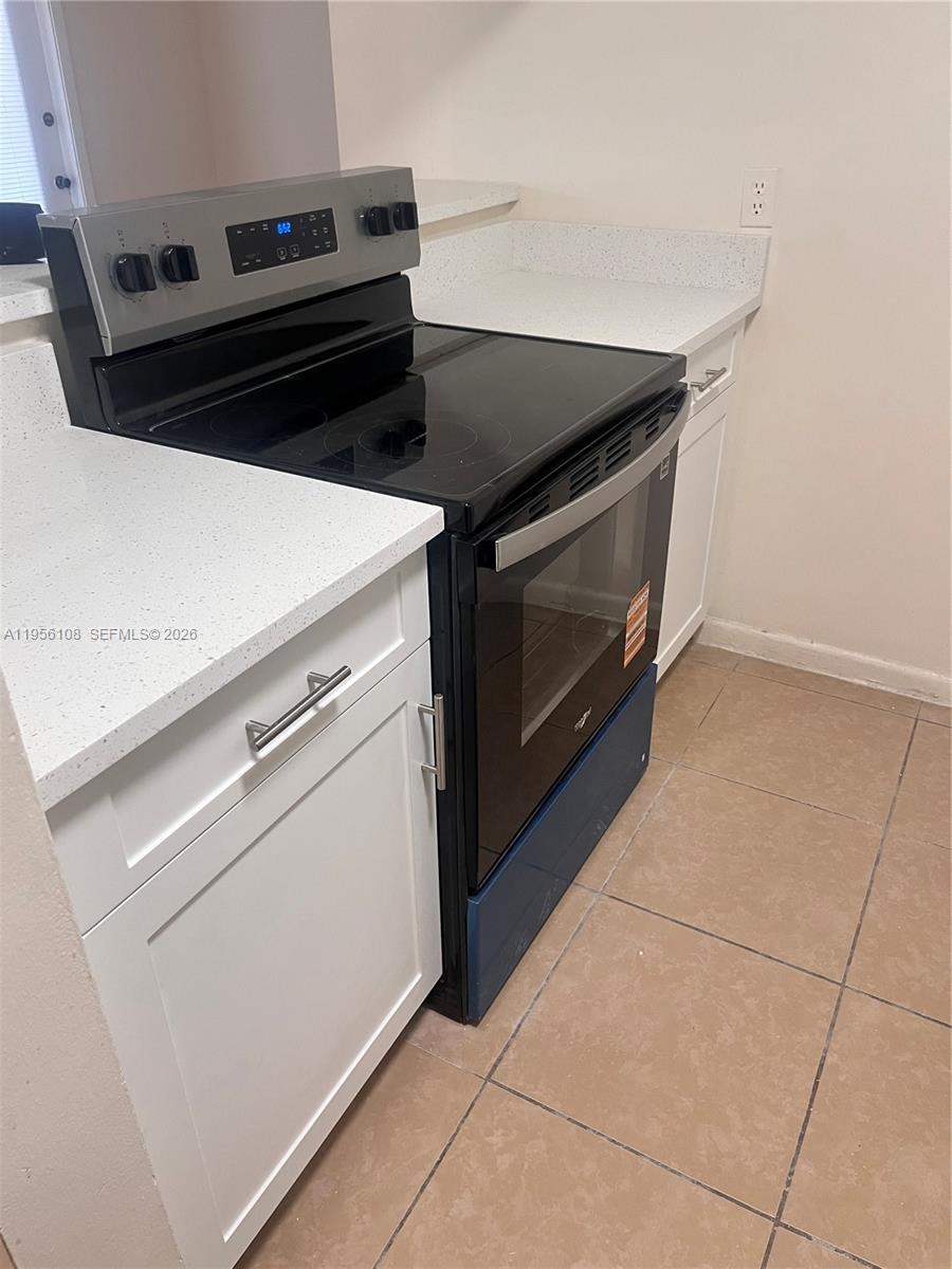 4281 West McNab Road, Unit 10 Pompano Beach, FL 33069 - Photo 3 of 16 a stove top oven sitting inside of a kitchen
