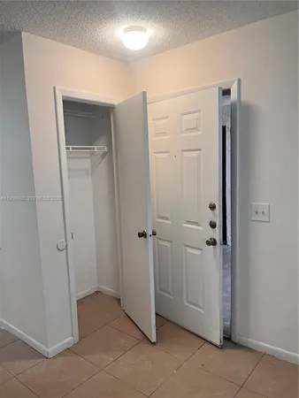 a view of a hallway with closet area