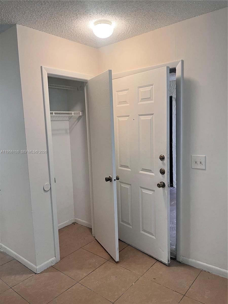 4281 West McNab Road, Unit 10 Pompano Beach, FL 33069 - Photo 6 of 16 a view of a hallway with closet area