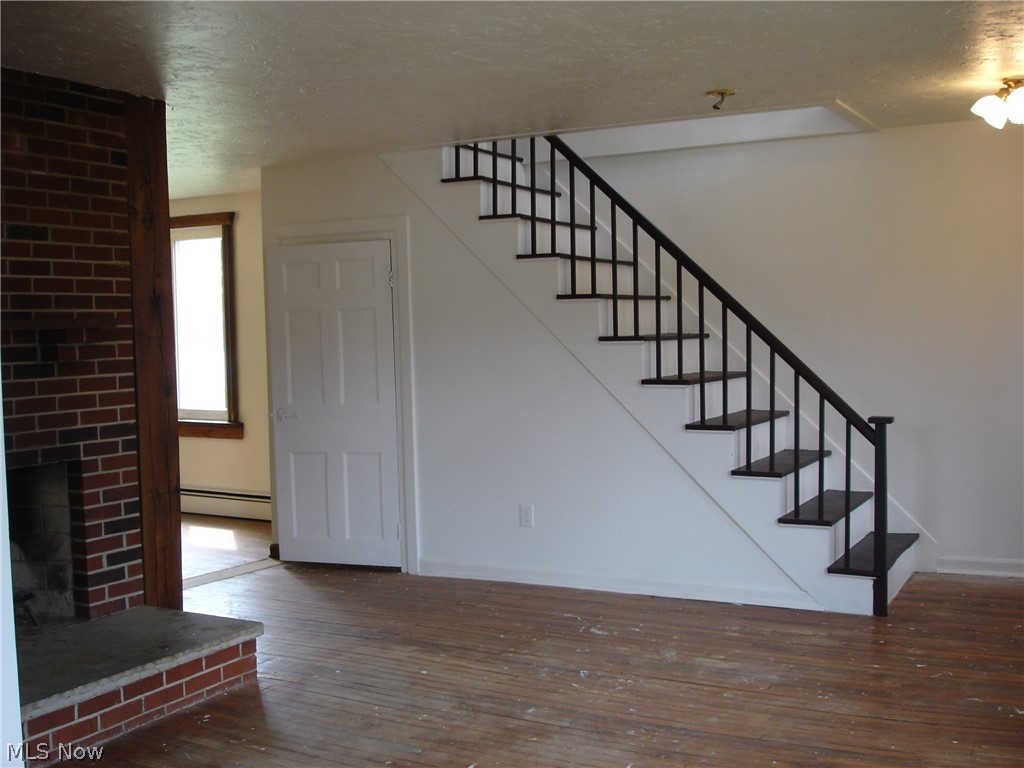 9733 Madison Road Montville, OH 44064 - Photo 15 of 31 2nd staircase in living room. Storage under the stairs in next pic.