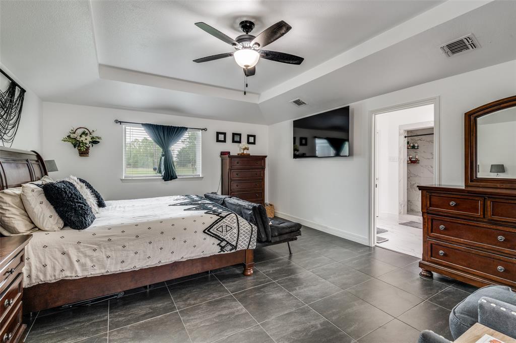 1301 Davis Lane Terrell, TX 75160 - Photo 24 of 37 a bedroom with a bed and a flat screen tv