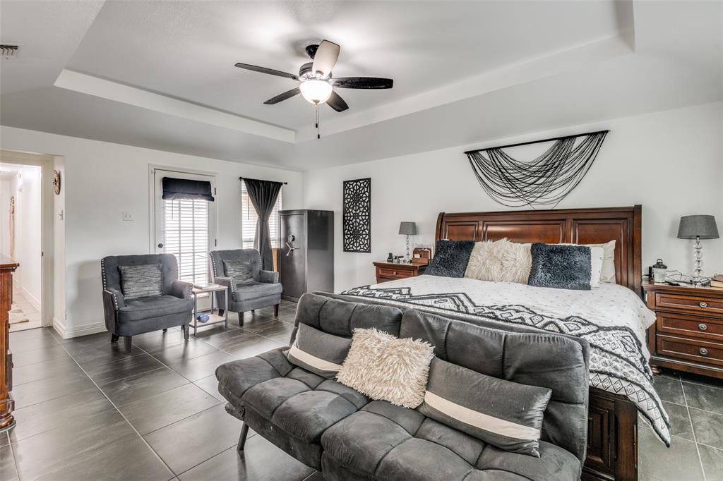 1301 Davis Lane Terrell, TX 75160 - Photo 25 of 37 a bedroom with furniture and a chandelier