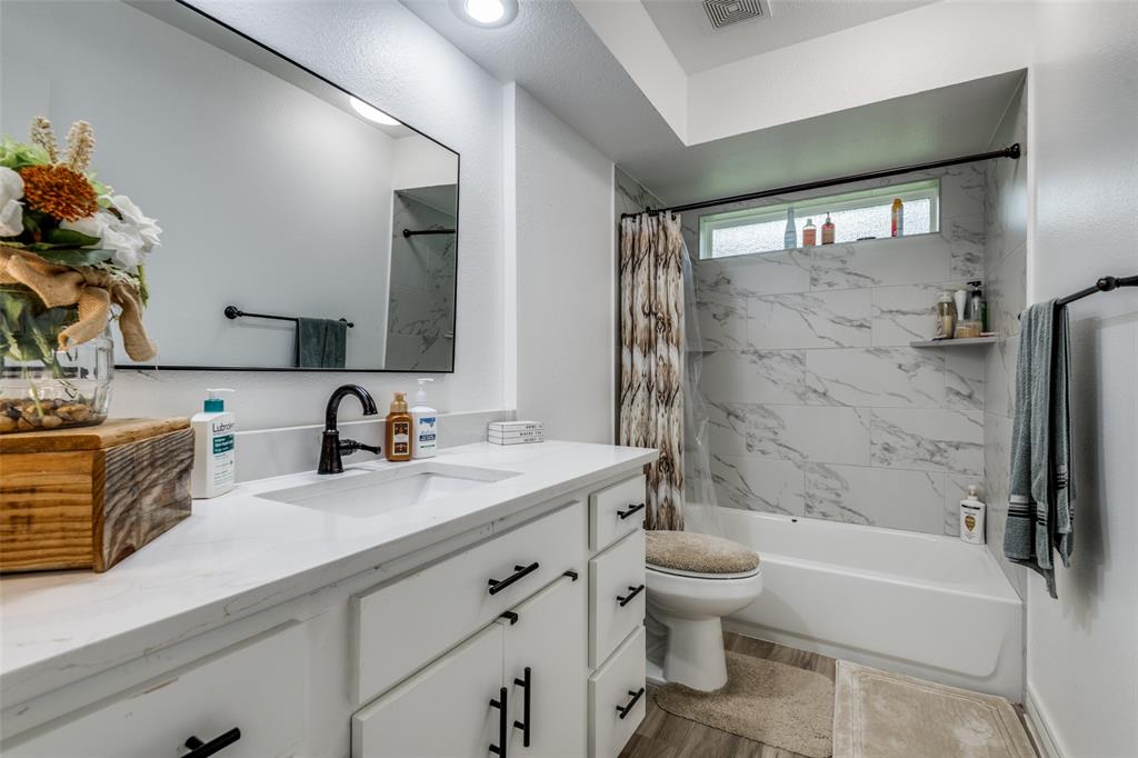 1301 Davis Lane Terrell, TX 75160 - Photo 29 of 37 a bathroom with a granite countertop sink toilet and shower