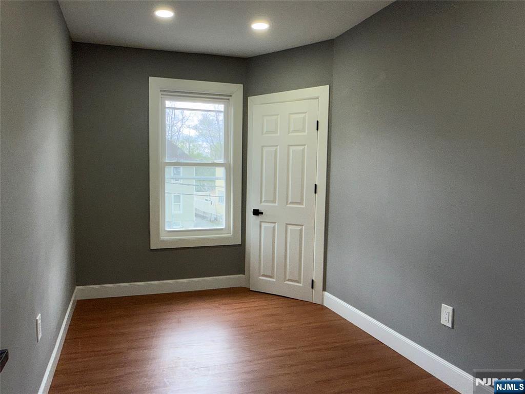 178 Berry Street Hackensack, NJ 07601 - Photo 11 of 22 an empty room with wooden floor and windows