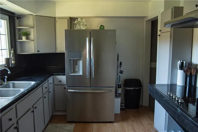 a kitchen with a refrigerator and a sink