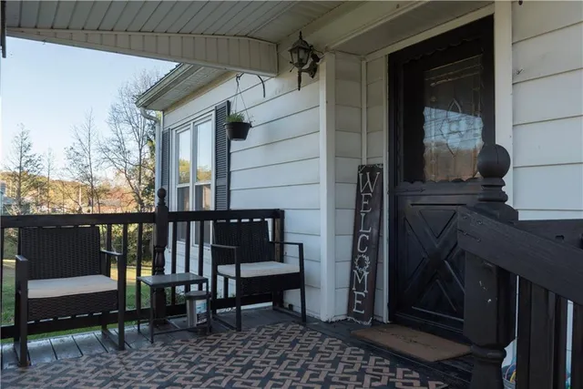 a view of a balcony with chairs and a table