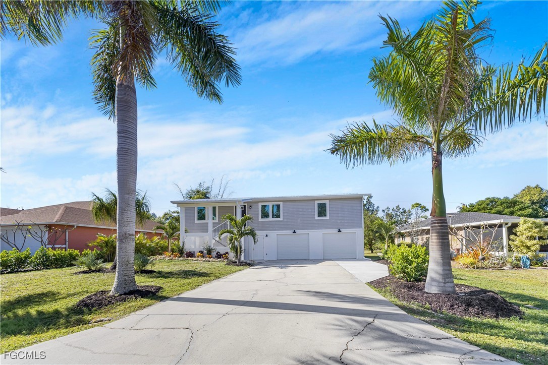 10697 Holly Road Bokeelia, FL 33922 - Photo 1 of 50 a front view of a house with garden