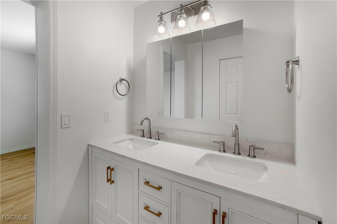 10697 Holly Road Bokeelia, FL 33922 - Photo 11 of 50 a bathroom with a sink and a mirror
