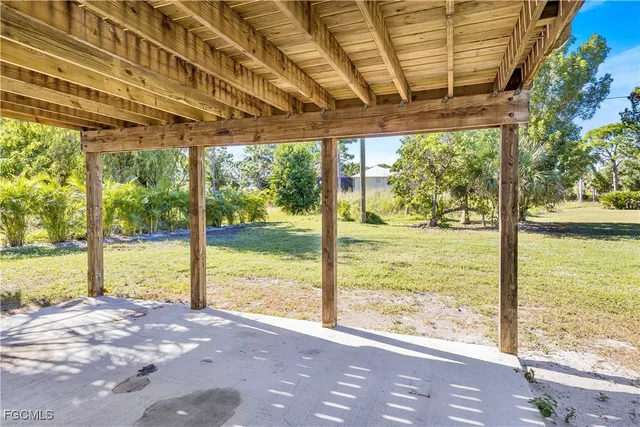 a view of a room with wooden floor and outdoor space
