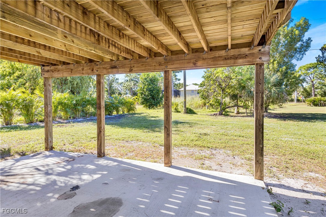 10697 Holly Road Bokeelia, FL 33922 - Photo 16 of 50 a view of a room with wooden floor and outdoor space