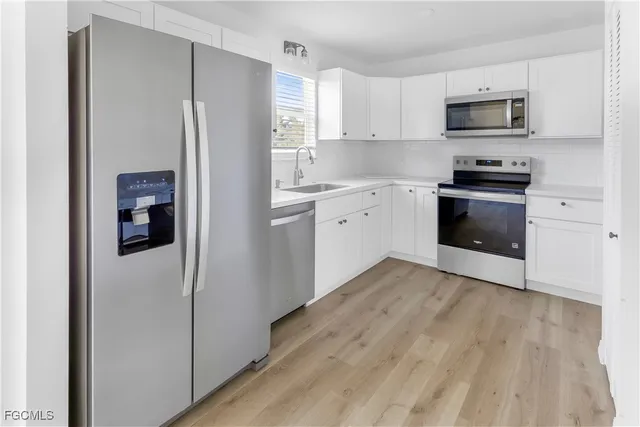 a kitchen with a refrigerator stove and microwave
