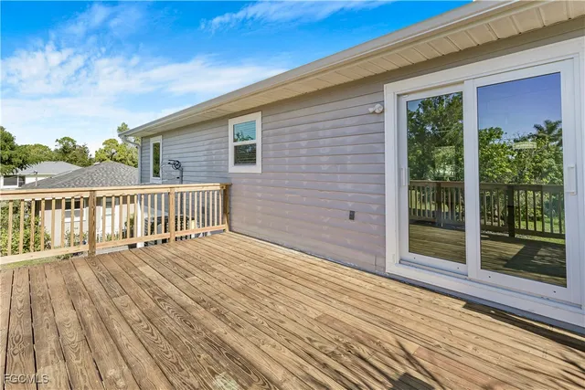 a view of a house with a wooden deck