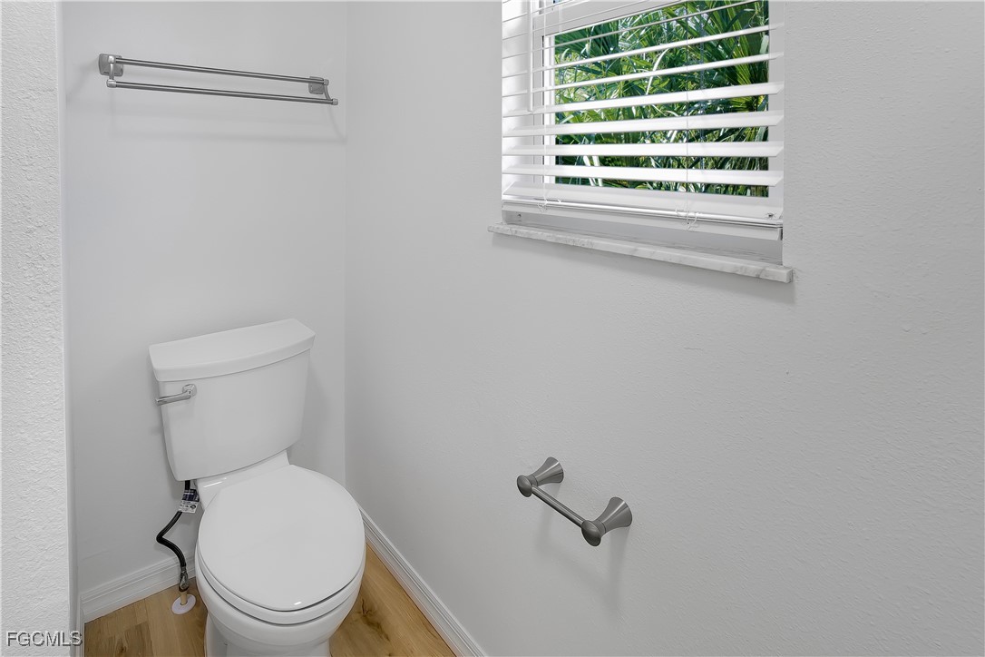 10697 Holly Road Bokeelia, FL 33922 - Photo 28 of 50 a white toilet sitting next to a window
