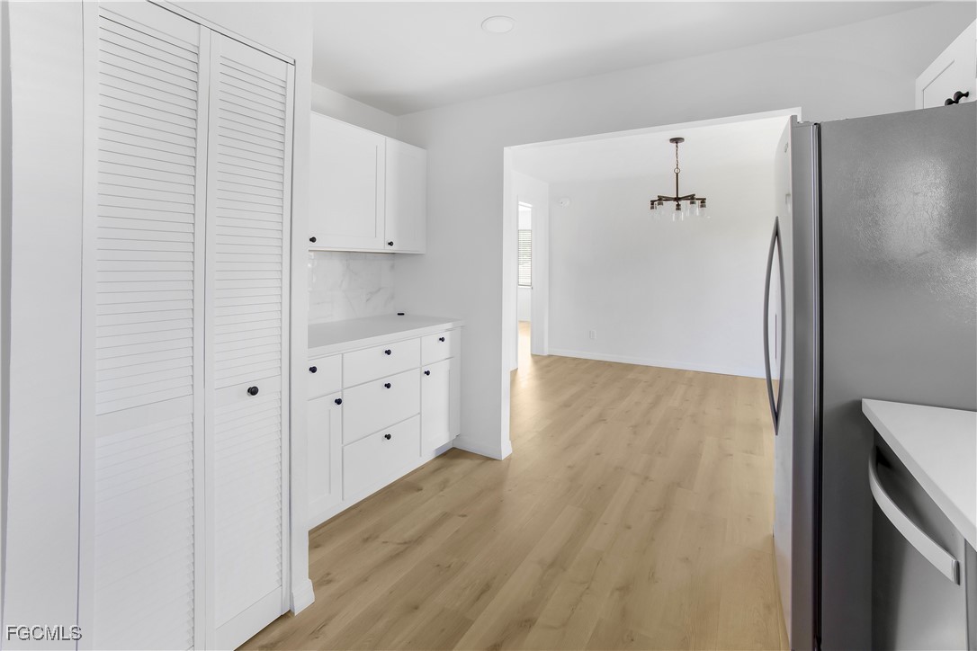 10697 Holly Road Bokeelia, FL 33922 - Photo 36 of 50 a view of hallway with wooden floor