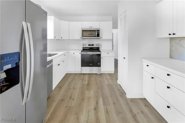 a kitchen with granite countertop a refrigerator and a stove