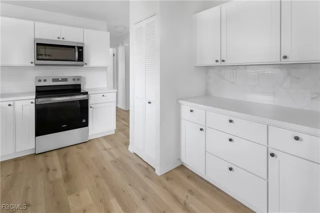 a kitchen with stainless steel appliances a stove microwave and refrigerator