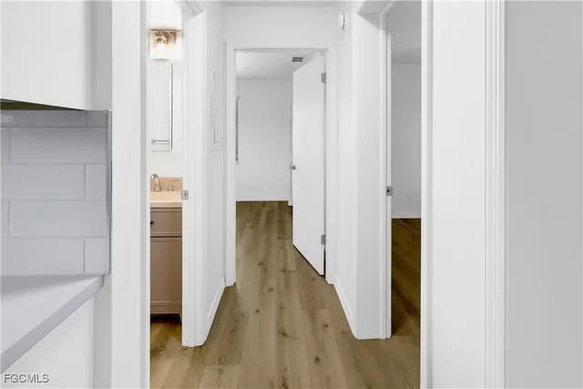 a view of hallway with wooden floor