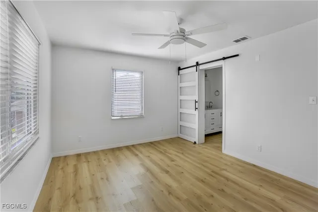 an empty room with windows and closet