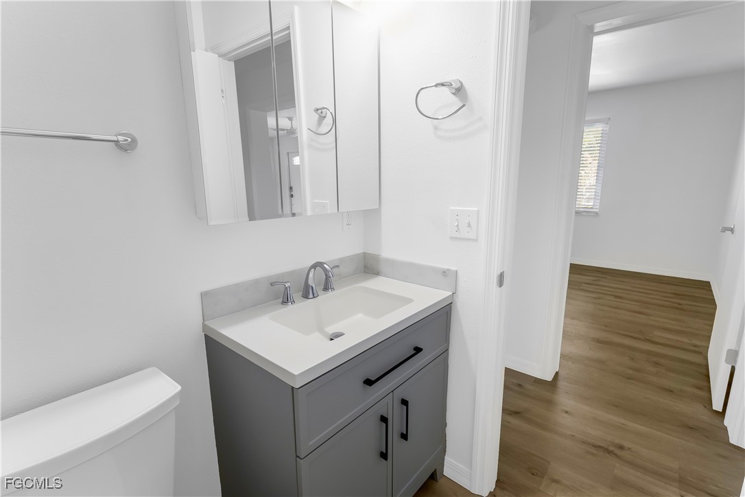 10697 Holly Road Bokeelia, FL 33922 - Photo 42 of 50 a bathroom with a sink toilet and mirror