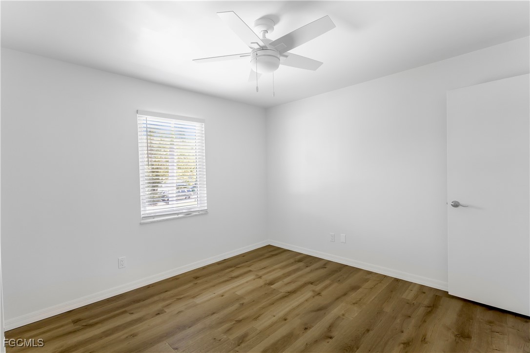 10697 Holly Road Bokeelia, FL 33922 - Photo 43 of 50 an empty room with a window and a ceiling fan
