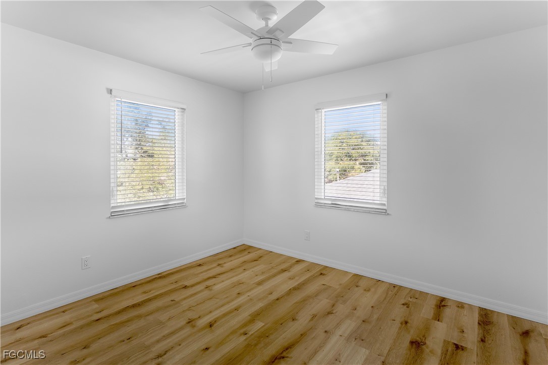 10697 Holly Road Bokeelia, FL 33922 - Photo 47 of 50 a view of empty room with wooden floor and fan