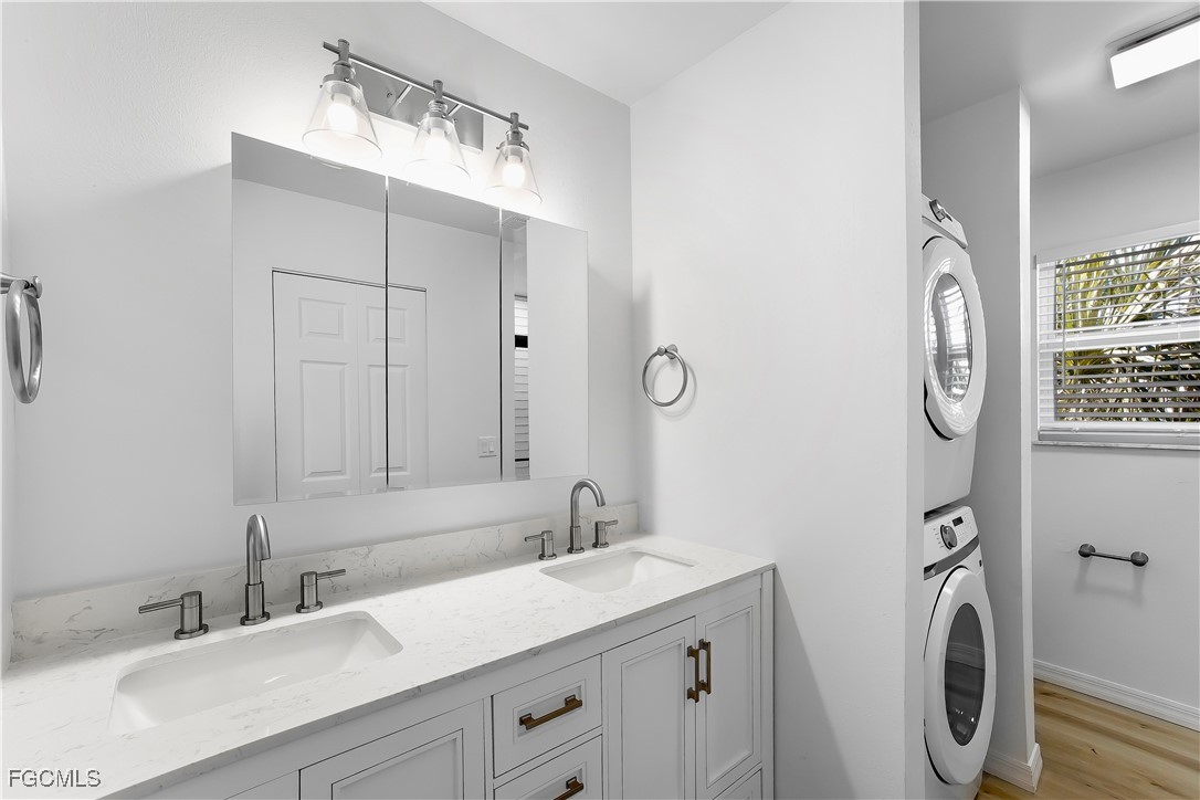 10697 Holly Road Bokeelia, FL 33922 - Photo 8 of 50 a bathroom with a sink vanity and a mirror