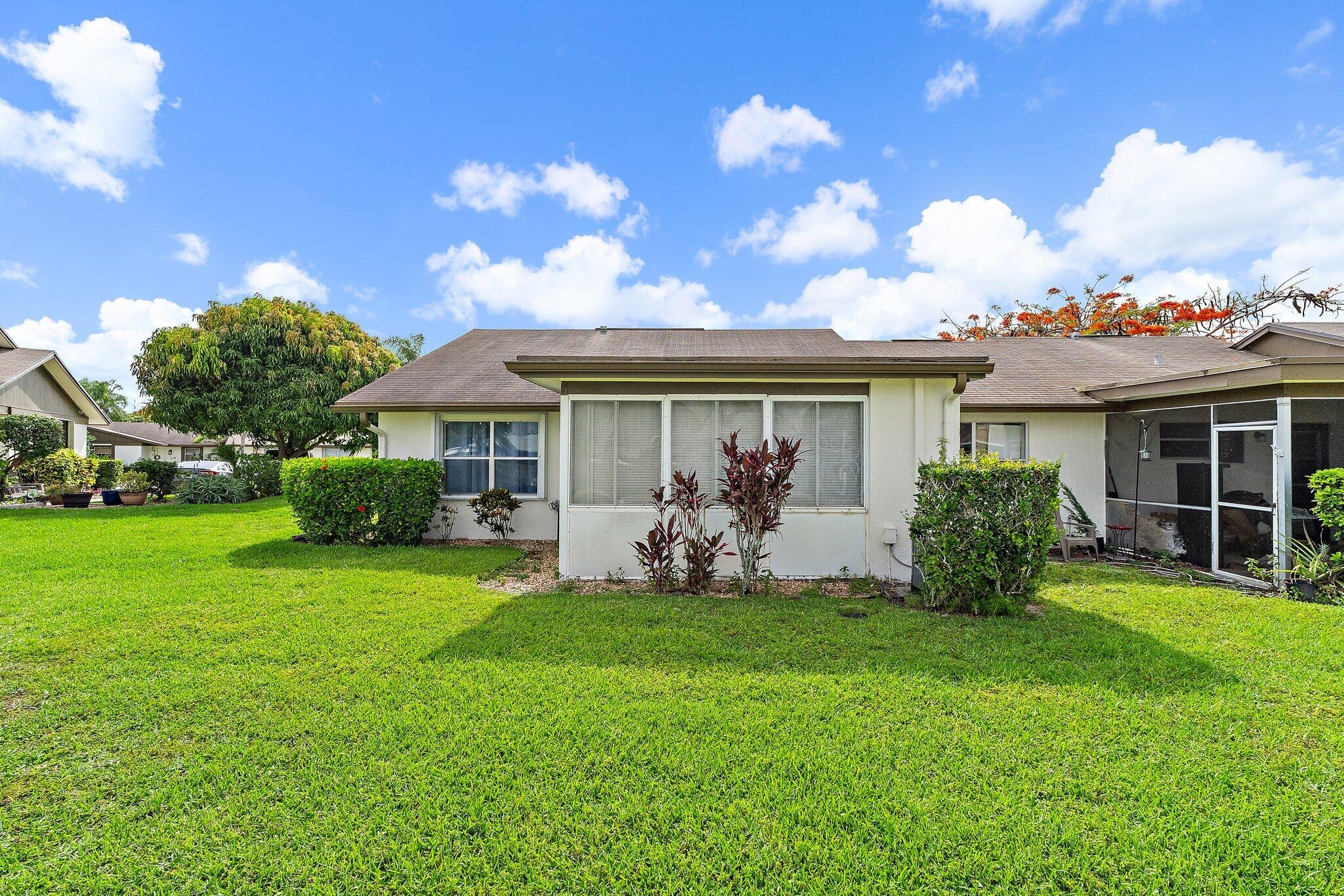 109 Doe Trail Jupiter, FL 33458 - Photo 25 of 26 a front view of a house with garden and porch