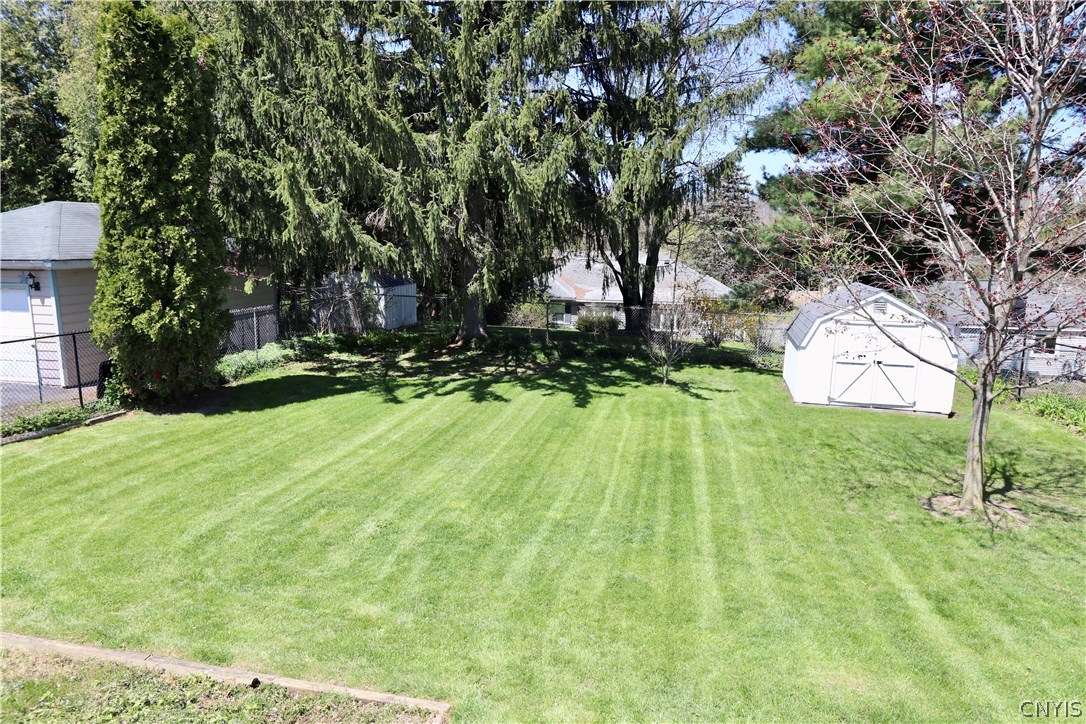417 Radcliffe Road DeWitt, NY 13214 - Photo 2 of 29 A spacious chain-link fenced-in backyard with a sh
