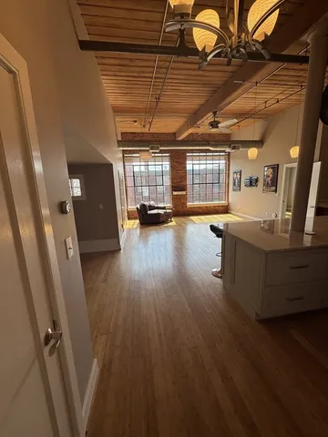 a view of a room with wooden floors and windows