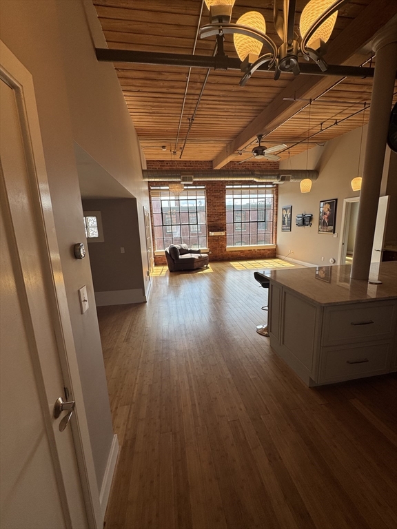 a view of a room with wooden floors and windows
