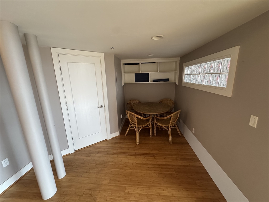 491 Dutton Street, Unit 504 Lowell, MA 01854 - Photo 11 of 16 a workspace room with wooden floor and furniture