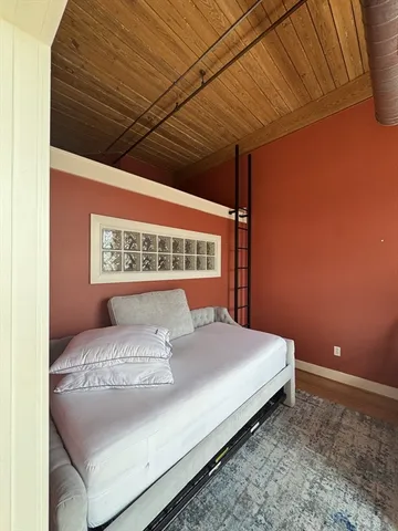 a bed sitting in a bedroom next to a wall