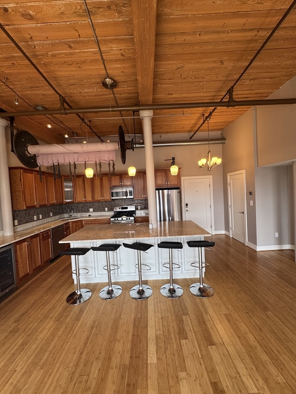 491 Dutton Street, Unit 504 Lowell, MA 01854 - Photo 3 of 16 a view of a big room with wooden floor