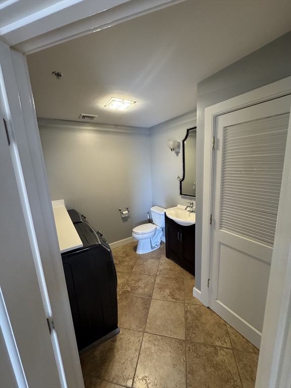 491 Dutton Street, Unit 504 Lowell, MA 01854 - Photo 7 of 16 a bathroom with a toilet