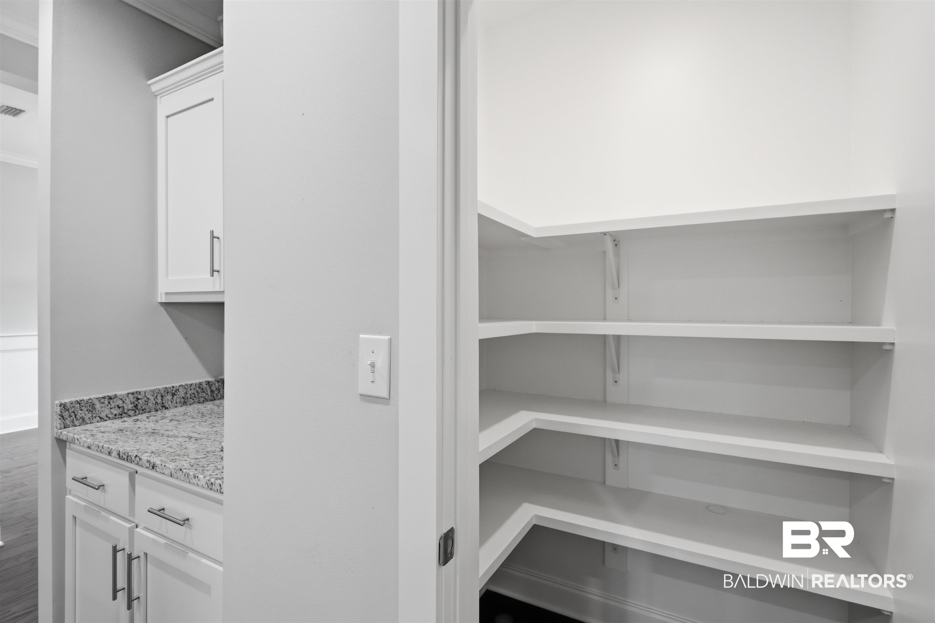 245 Divot Loop Fairhope, AL 36532 - Photo 12 of 26 Walk-in pantry with multiple tiers of white shelving
