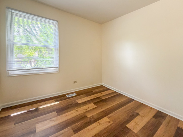 5090 Prairie Oak Road Gurnee, IL 60031 - Photo 12 of 30 a view of a room with wooden floor and a window
