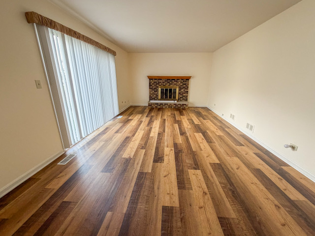 5090 Prairie Oak Road Gurnee, IL 60031 - Photo 18 of 30 a view of a room with wooden floor and a window