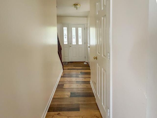 5090 Prairie Oak Road Gurnee, IL 60031 - Photo 24 of 30 a view of a hallway with wooden floor and staircase